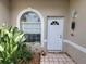 Entrance featuring a decorative window, a white door, and tiled flooring offers a warm welcome at 6916 Stoneywalk Ct # 6916, Bradenton, FL 34203