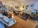 A cozy living room with hardwood floors, a comfortable sofa, stylish chairs, and decorative artwork creates a warm ambiance at 6916 Stoneywalk Ct # 6916, Bradenton, FL 34203