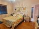 Comfortable bedroom with hardwood floors, a floral-themed bedspread, and plenty of natural light offers a serene retreat at 6916 Stoneywalk Ct # 6916, Bradenton, FL 34203