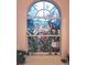 Beautiful bathroom window with custom stained glass featuring cranes and tropical plants at 6916 Stoneywalk Ct # 6916, Bradenton, FL 34203