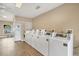 A clean, shared laundry room with multiple high-efficiency washing machines at 7 Brookshire Dr, Nokomis, FL 34275