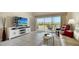 Bright living room with tile flooring, a large screen television, and sliding glass doors to the patio at 7214 Cedar Hollow Cir, Bradenton, FL 34203