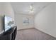 A bright bedroom with neutral carpet, center ceiling fan, closet, and a window for great natural light at 7312 Eleanor Cir, Sarasota, FL 34243