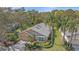 Charming single-story home with a well-manicured front yard, mature landscaping, and a view of a serene pond at 7312 Eleanor Cir, Sarasota, FL 34243