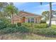 Charming house with a bay window and colorful stucco, surrounded by well-kept shrubs and greenery at 7312 Eleanor Cir, Sarasota, FL 34243