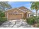 Well-maintained home with a spacious driveway and a two-car garage featuring decorative window accents at 7312 Eleanor Cir, Sarasota, FL 34243