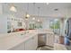 Bright kitchen with breakfast bar overlooking the Gathering room, stainless appliances, and neutral decor at 7312 Eleanor Cir, Sarasota, FL 34243