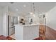 Bright eat-in kitchen featuring stainless steel appliances, white cabinets, and breakfast bar at 7312 Eleanor Cir, Sarasota, FL 34243