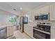 Kitchen with stainless steel appliances and views of the lanai at 7312 Eleanor Cir, Sarasota, FL 34243