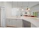 Bright kitchen featuring stainless steel appliances, white cabinets, and views to the lanai at 7312 Eleanor Cir, Sarasota, FL 34243