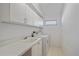 Clean laundry room with washer, dryer, utility sink, and lots of cabinet space at 7312 Eleanor Cir, Sarasota, FL 34243