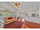 Open-concept living space featuring hardwood floors, a spacious layout, and views of the lanai at 7312 Eleanor Cir, Sarasota, FL 34243