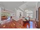 Open-concept living space featuring hardwood floors, a dining area, and a view of the screened in lanai at 7312 Eleanor Cir, Sarasota, FL 34243