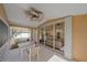 Relaxing screened patio with ceiling fan and outdoor seating near sliding glass doors at 7312 Eleanor Cir, Sarasota, FL 34243