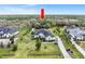 Aerial view of a home nestled among mature trees with a large lawn and long driveway leading up to the house at 7601 226 E St, Bradenton, FL 34211