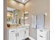 A bright bathroom has a marble vanity sink, drawers, and large mirror at 7601 226 E St, Bradenton, FL 34211