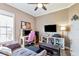 This bedroom features a desk, workspace, futon couch, and wall-mounted TV at 7601 226 E St, Bradenton, FL 34211