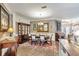 Elegant dining room features a large wooden table, chairs, a display cabinet, and sophisticated decor at 7601 226 E St, Bradenton, FL 34211