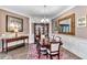 Elegant dining room features a large wooden table, chairs, a display cabinet, and sophisticated decor at 7601 226 E St, Bradenton, FL 34211