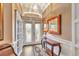 Inviting foyer with elegant lighting, decorative mirror, and stylish console table showcasing the home's charm at 7601 226 E St, Bradenton, FL 34211