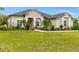 Charming single-story home with a well-manicured lawn, mature landscaping, and a lovely front garden with a small fountain at 7601 226 E St, Bradenton, FL 34211
