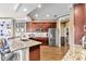 Stylish kitchen with stainless steel appliances, granite countertops and wooden floors at 7601 226 E St, Bradenton, FL 34211