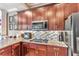 Updated kitchen with granite countertops, mosaic backsplash, and stainless steel appliances at 7601 226 E St, Bradenton, FL 34211