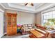 Comfortable living room with a brown leather sofa, wooden hutch, and tray ceiling at 7601 226 E St, Bradenton, FL 34211