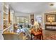 Comfortable living room with stylish furnishings, built-in bookshelves, and a view of the backyard pool at 7601 226 E St, Bradenton, FL 34211