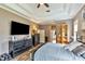 A main bedroom features tray ceilings, lots of dresser storage, and a large screen TV at 7601 226 E St, Bradenton, FL 34211