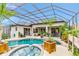 The screened-in pool and spa are surrounded by plants at 7601 226 E St, Bradenton, FL 34211