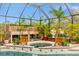 The screened-in hot tub is surrounded by plants at 7601 226 E St, Bradenton, FL 34211