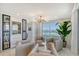 Stylish living room with a modern lighting fixture, a large window view, and marble style flooring at 775 Longboat Club Rd # 604, Longboat Key, FL 34228