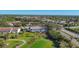 Aerial view of a condo complex with a golf course, showcasing community and recreational amenities at 801 Montrose Dr # 202, Venice, FL 34293