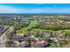 Aerial view of community featuring lush landscaping, golf course, lakes, and condo buildings at 801 Montrose Dr # 202, Venice, FL 34293