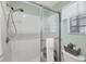 Modern bathroom featuring glass enclosed shower, white tile, and updated fixtures for a clean, spa-like experience at 801 Montrose Dr # 202, Venice, FL 34293