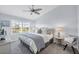 Bedroom with large window, ceiling fan, comfy chair, and a coastal, neutral color palette at 801 Montrose Dr # 202, Venice, FL 34293