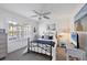 Cozy bedroom with coastal decor, ceiling fan, and natural light from the window, creating a relaxing retreat at 801 Montrose Dr # 202, Venice, FL 34293