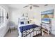 Comfortable bedroom with white walls, ceiling fan, and coastal-themed decor, ideal for relaxation and rest at 801 Montrose Dr # 202, Venice, FL 34293