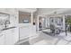 Bright eat-in kitchen with white cabinetry, dishwasher, sink, and view to porch with table and chairs at 801 Montrose Dr # 202, Venice, FL 34293