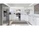 Bright kitchen featuring stainless steel appliances, white cabinets, tile floors and neutral decor at 801 Montrose Dr # 202, Venice, FL 34293