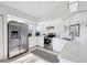 Bright kitchen with stainless steel appliances, white cabinetry, and tile floors at 801 Montrose Dr # 202, Venice, FL 34293