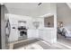 Bright kitchen with stainless steel appliances, white cabinetry, and tile floors open to living area at 801 Montrose Dr # 202, Venice, FL 34293