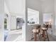 Bright kitchenette area with bar-top seating and stainless steel refrigerator at 801 Montrose Dr # 202, Venice, FL 34293