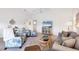 Open-concept living room with vaulted ceiling, ceiling fan, comfortable furniture, and a TV at 801 Montrose Dr # 202, Venice, FL 34293