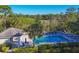 Bright community pool surrounded by a manicured lawn and lush trees at 801 Montrose Dr # 202, Venice, FL 34293