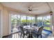 Enclosed sun room/porch with dining table, ceiling fan, and views of the outside at 801 Montrose Dr # 202, Venice, FL 34293