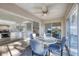 Enclosed sun room/porch with dining table, ceiling fan, and views of the outside at 801 Montrose Dr # 202, Venice, FL 34293