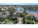 Stunning aerial view of the estate, showcasing lush landscaping, serene lake, and neighboring properties at 820 Placid Lake Dr, Osprey, FL 34229