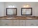 Bathroom features double sinks with granite countertops, modern lighting, and framed mirrors at 820 Placid Lake Dr, Osprey, FL 34229